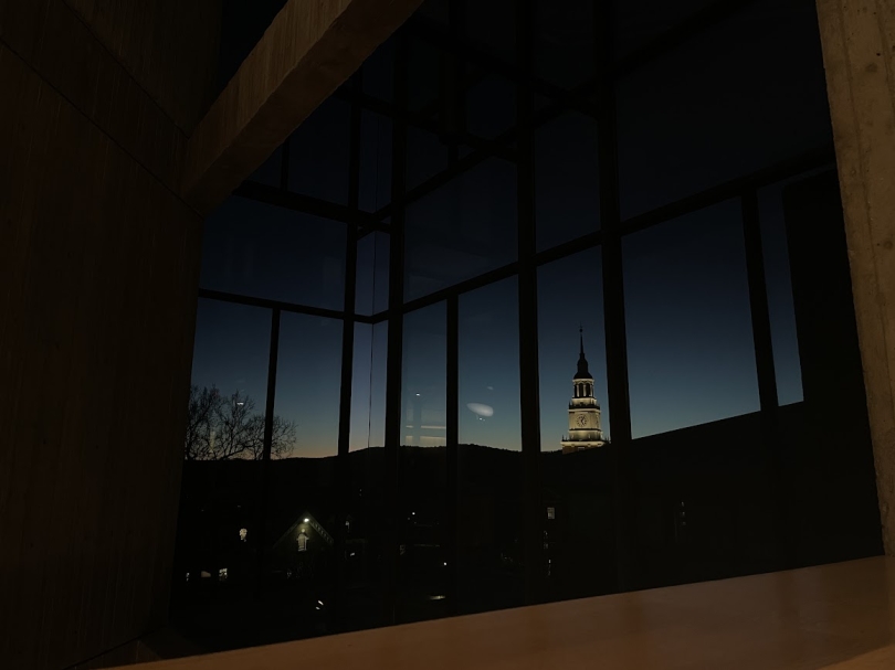 a picture of Baker Tower seen through the windows of Fairchild fourth floor when there's just a little bit of afterglow still present in the sky