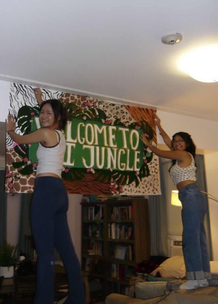 A picture of me and my friend hanging up a banner