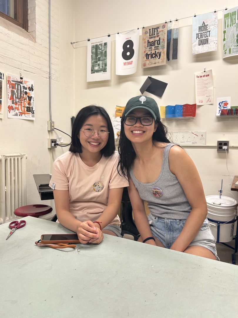 Taylor '27 and Diana '23 wearing the buttons made in the Book Arts Studio