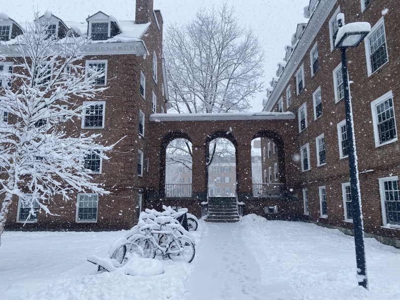 a picture of a dartmouth dorm and bikes covered in snow!
