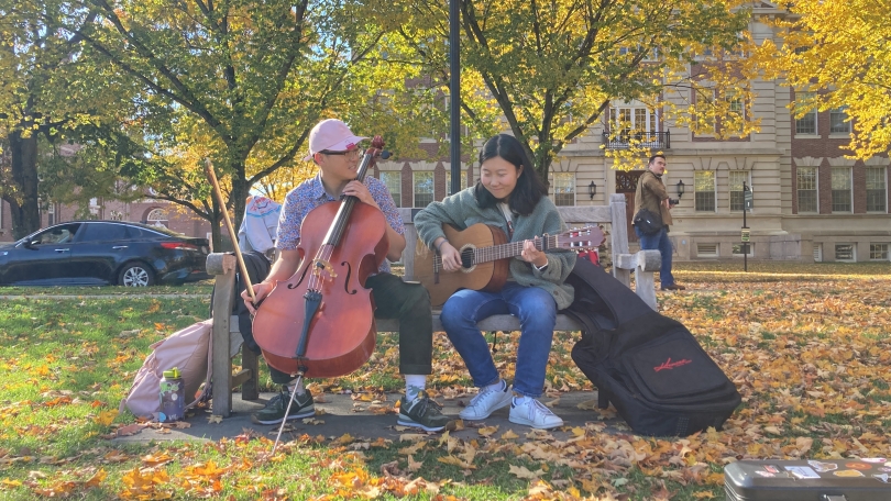 two people playing a guitar and cello