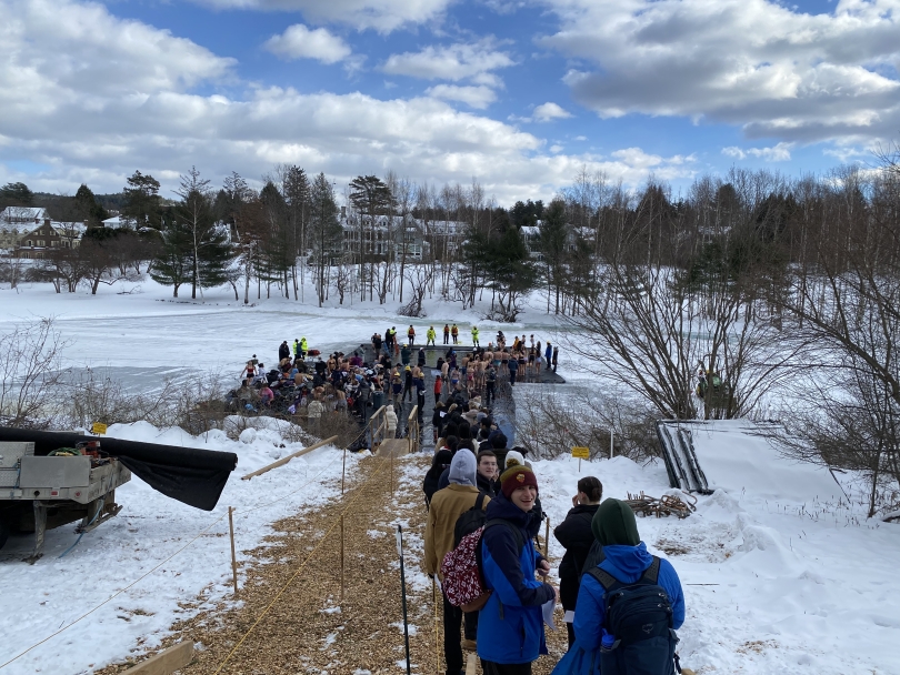 Students waiting in line to complete Dartmouth's Winter Carnival Polar Plunge in Occom Pond, a hole cut into the ice. 