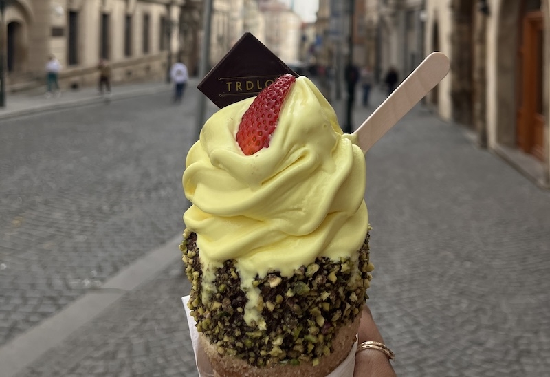 An image of an ice cream cone with yellow ice cream 