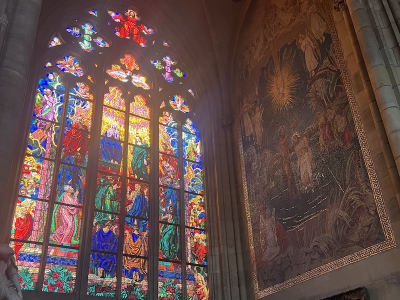 An image of an intricate glass mosaic window in a cathedral