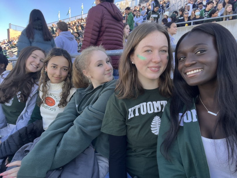 Selfie of me and friends at the homecoming game, all sporting green Dartmouth merchandise