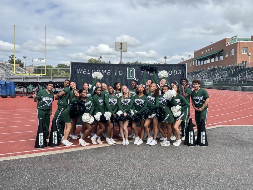 Cheerleaders making funny faces and having fun on the sidelines, showcasing their playful side.