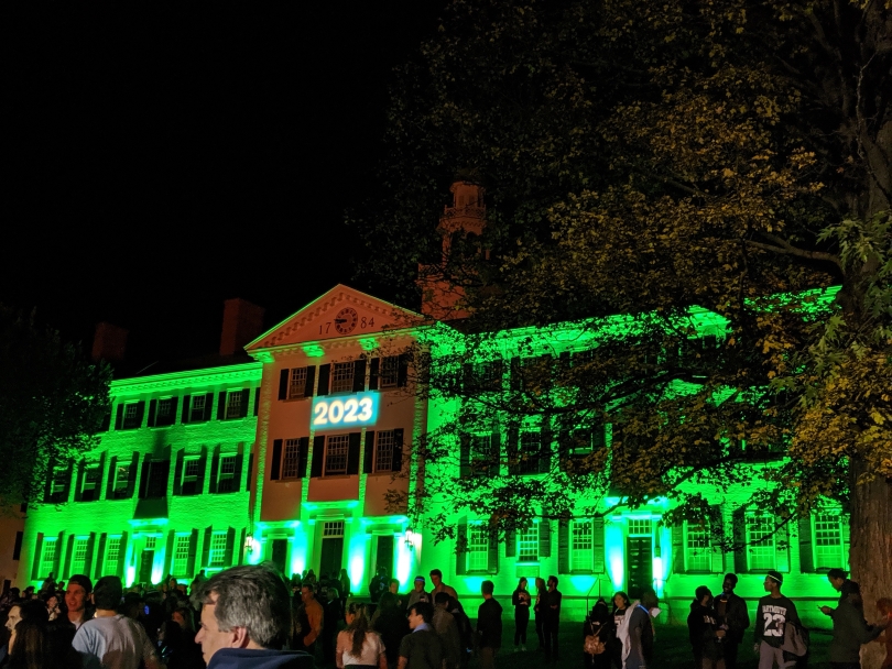 Dartmouth Hall lit up green for the '23s