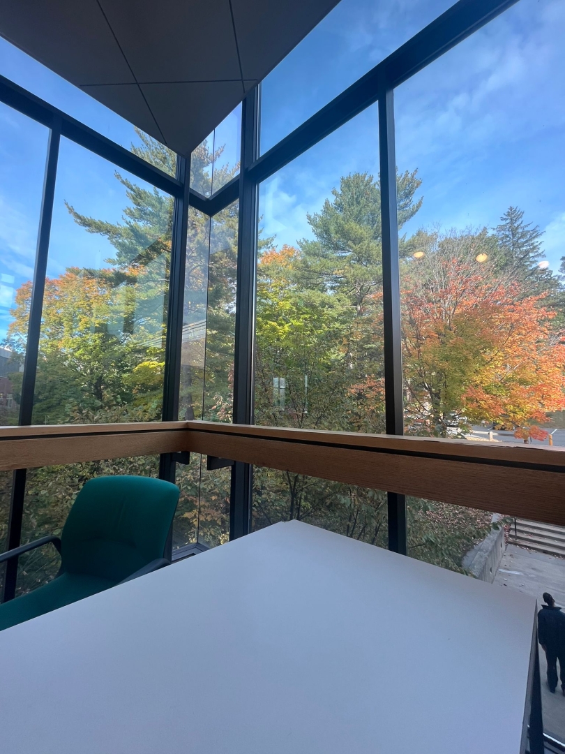 Study spot facing a large glass window with a great view of nature