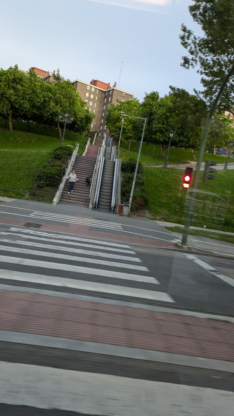  A public escalator that I see on my commute back to my host mom's apartment. There are also stoplights for crosswalks.