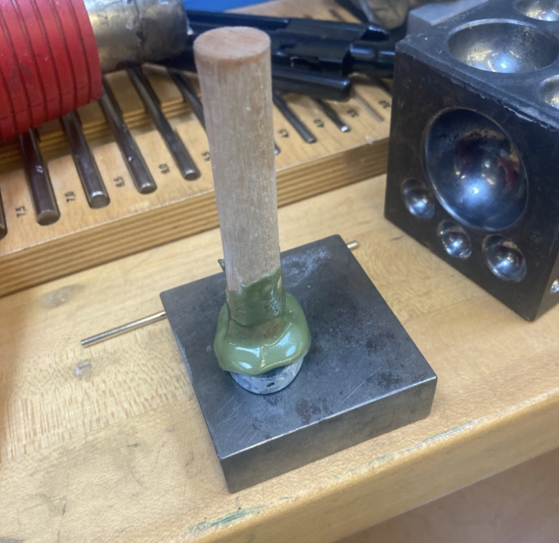 the stone it attached to a stick with wax