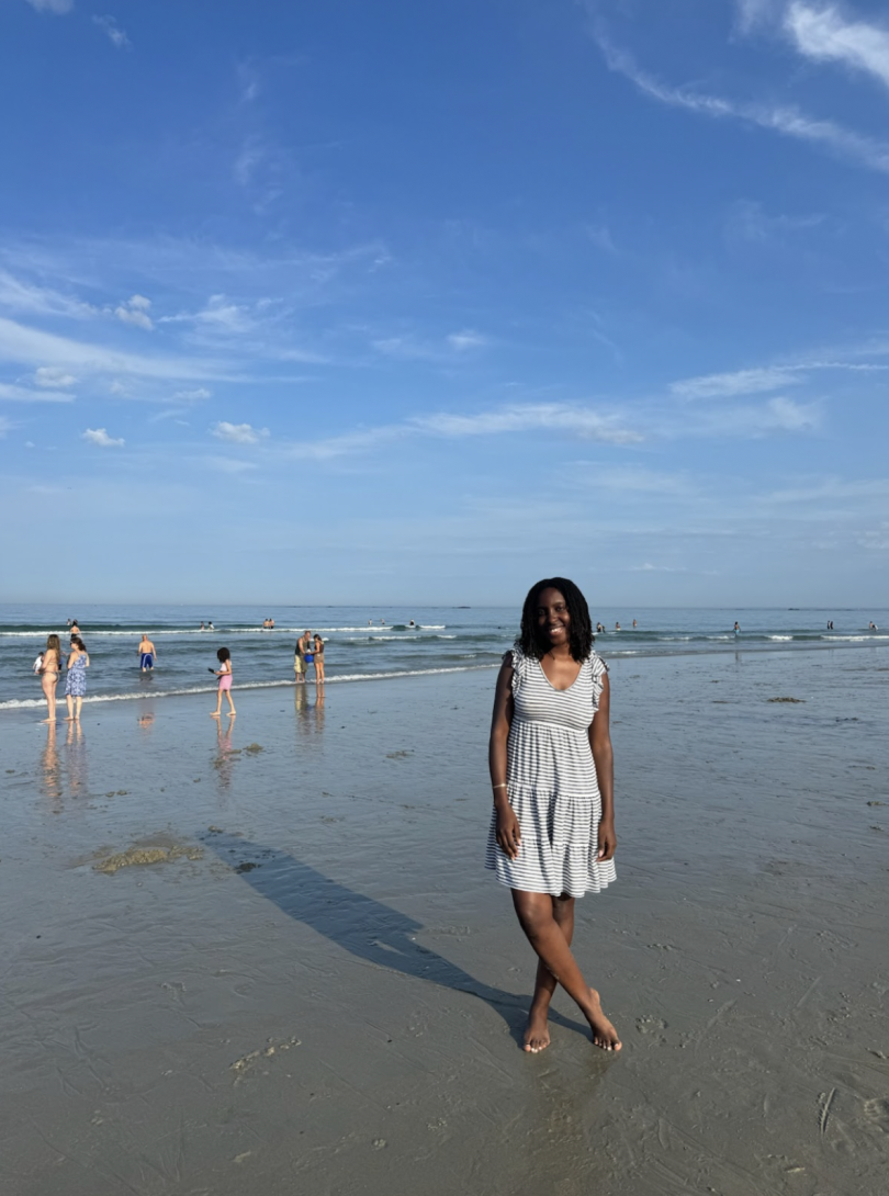A photo of me standing on the sand near the ocean!