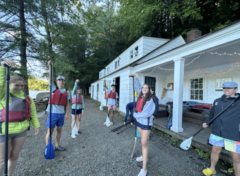 Trippees holding paddles