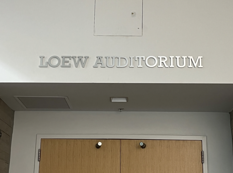 A doorway with a sign above that reads Loew Auditorium. 