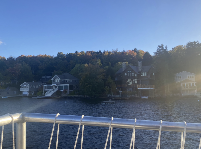 Three lake houses along a lakeshore, with forest in between each one