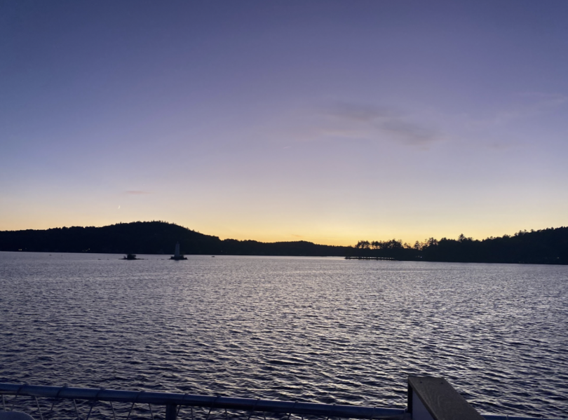 A lake sunset with a dark blue to purple to yellow gradient