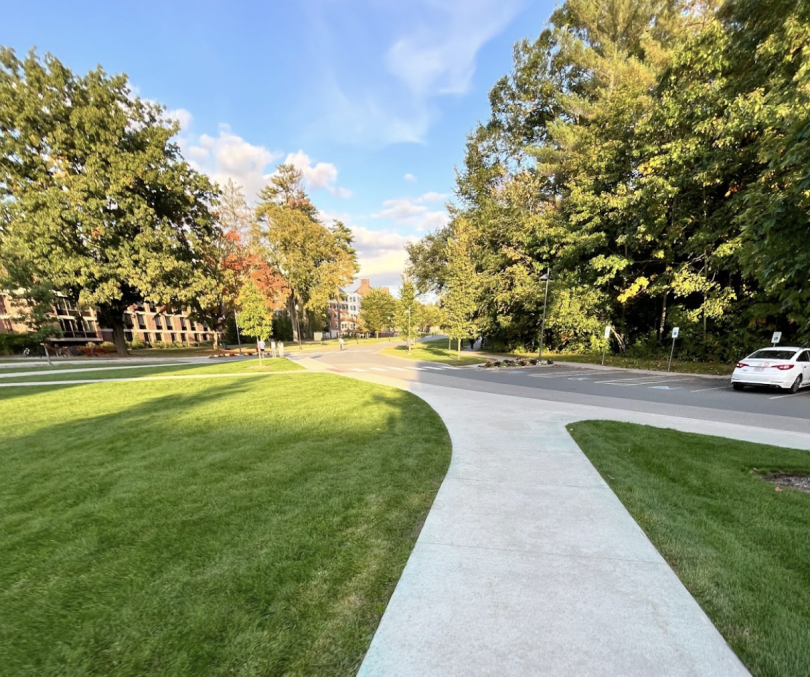 Another beautiful view on my walks to the rest of campus from the River. Tuck Mall stretches into the background, the sun is shining on the trees and the clouds, you can vaguely see more West House buildings in the background.
