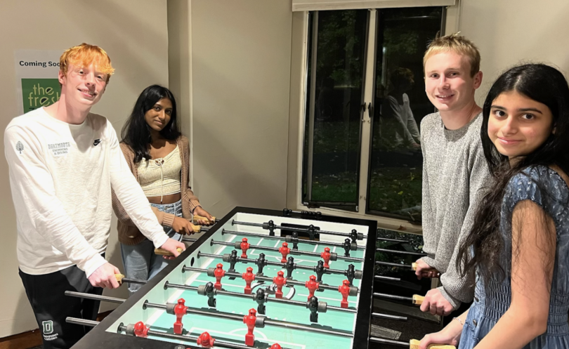 4 friends at foosball table