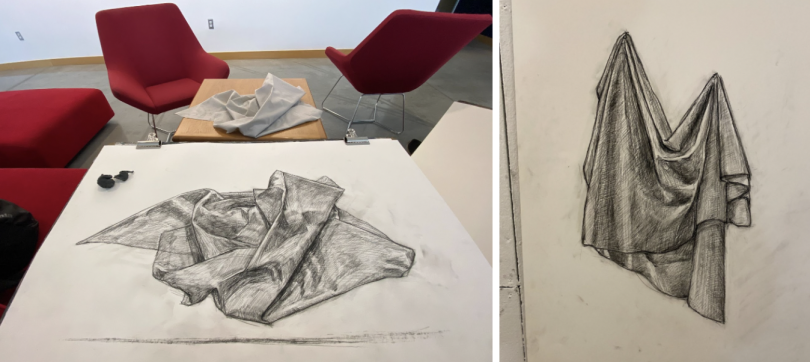 An image of a folded cloth live reference and charcoal drawing. A charcoal drapery drawing. 