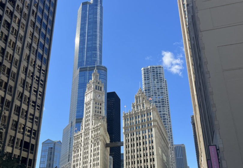 An image of the Chicago skyline. The sky is blue and there are tall buildings. 