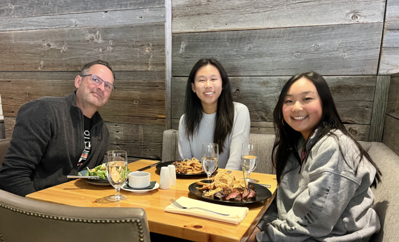 Madison, Cayla, and a professor eating at the Pine restaurant