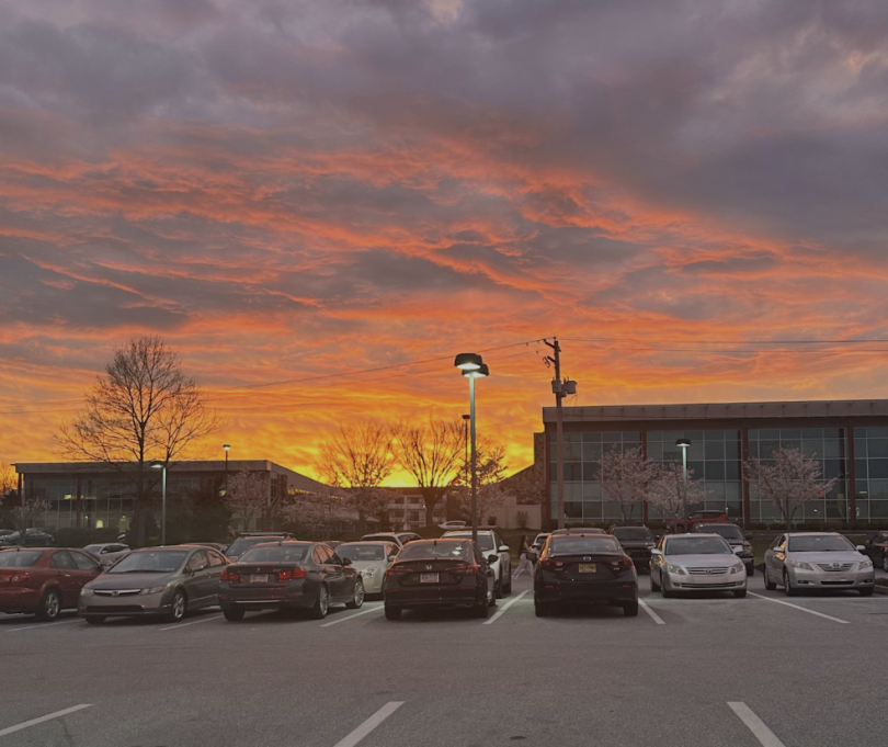 Parking lot with the sunset over it.