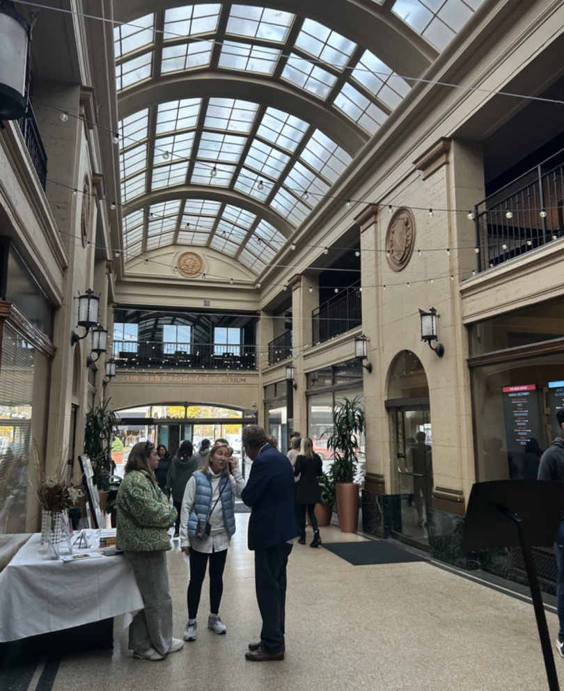 A picture of an atrium with people talking inside.