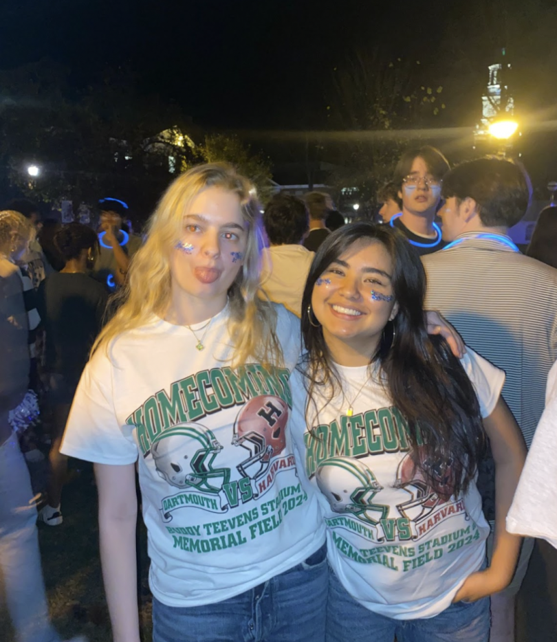 Two girls standing at the bonfire