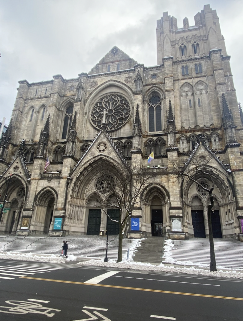 Gothic-style cathedral with a rose window and snow-covered steps.
