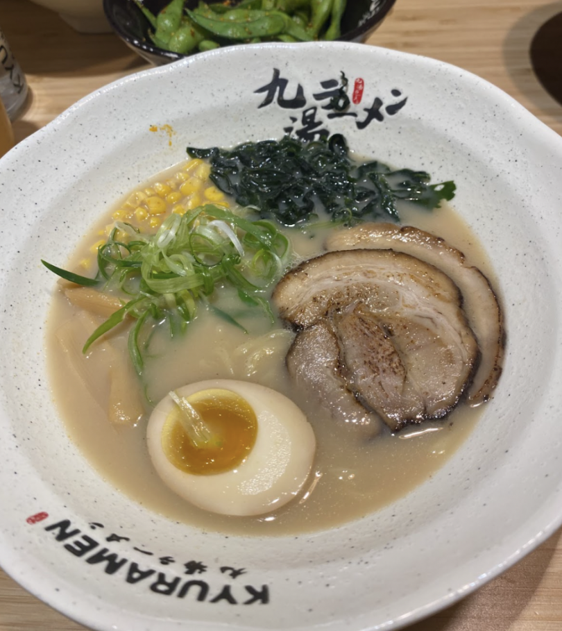 Bowl of ramen with chashu, egg, scallions, seaweed, and corn.