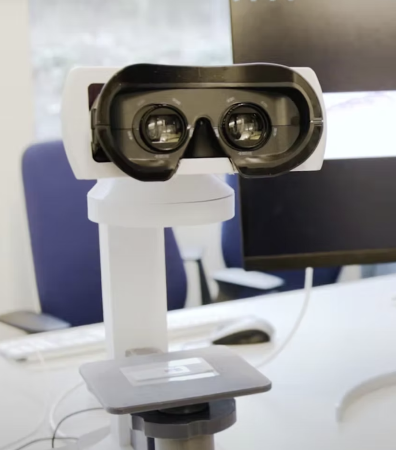 a picture of a white microscope, its scope in the front of the picture
