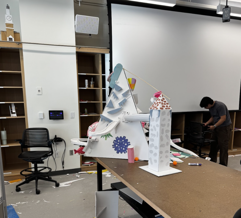 Image featuring a roller coaster built out of foam core. The roller coaster features several elements from a Skiway such as a white mountain, several runs, drops, and more. The roller coaster set on a table.