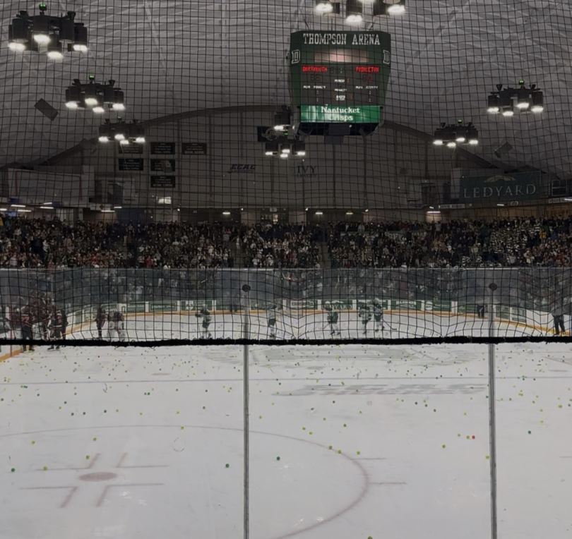 Image featuring the ice rink in the Thompson Area at Dartmouth. People can be seen throwing tennis balls over the nets surrounding the ice rink. Several Dartmouth and Pricenton Hockey players can also be seen exiting the ice rink as tennis ball