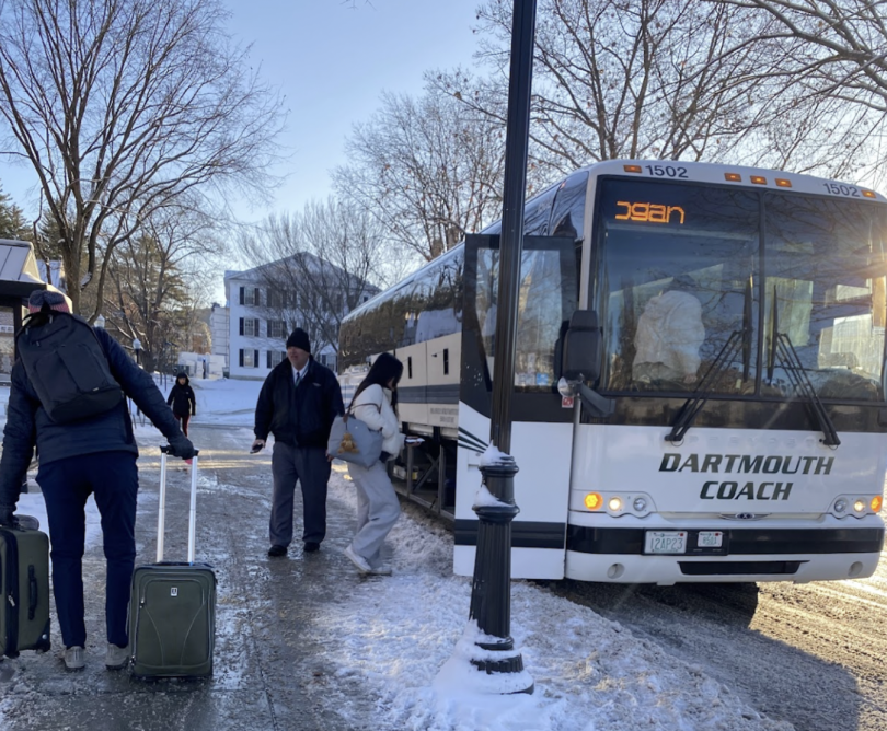 A bus labeled "Dartmouth Coach" is shown with Dartmouth buildings in the background. Passengers are climbing in.