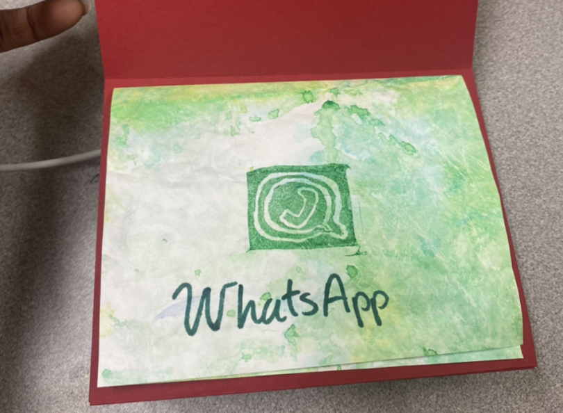 A photo of the green cover of my book with the WhatsApp logo.