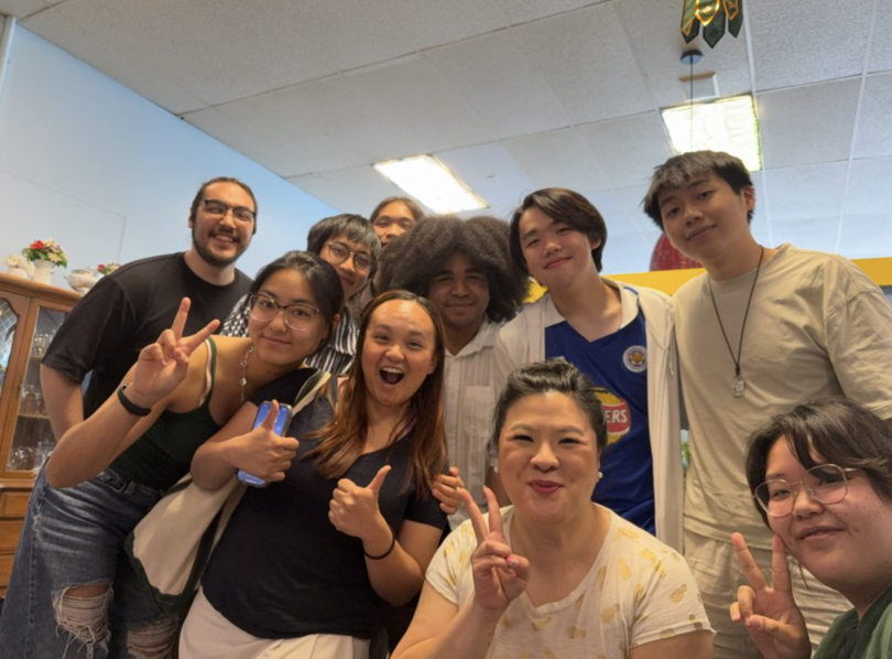 The AAPIHM 2025 planning committee together in a group picture. I'm peeking out of the background.