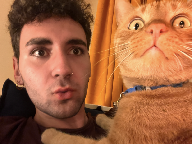 The blogger posing with their orange cat.