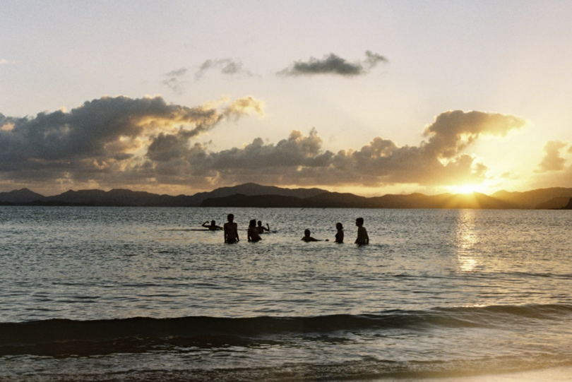 students swimming at sunrise