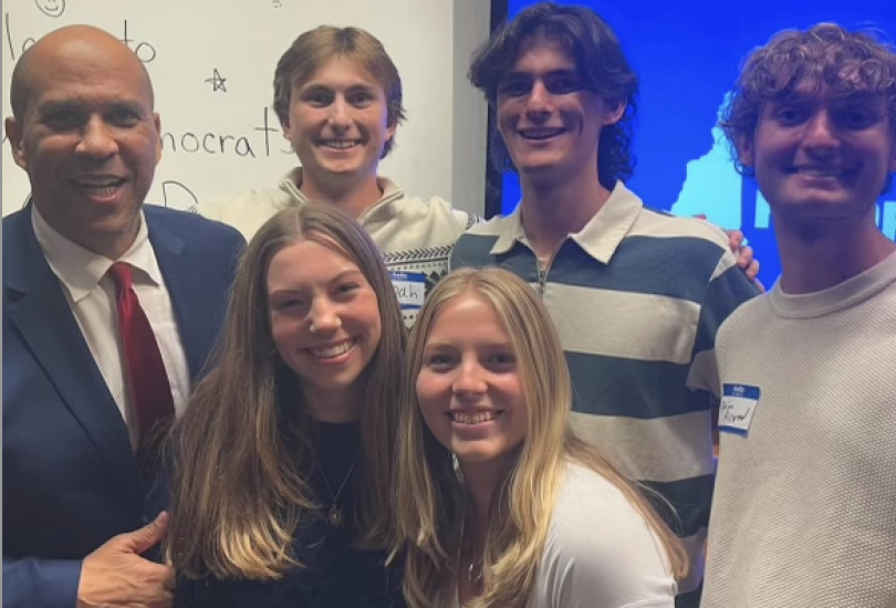 A group of 6 people stand together.