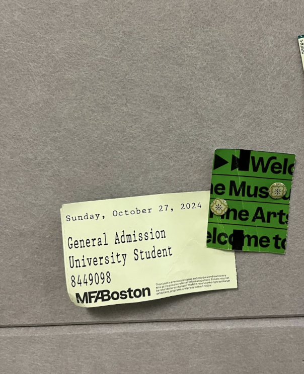 Two halves of the ticket, one green and one white, are pinned up on a purple board