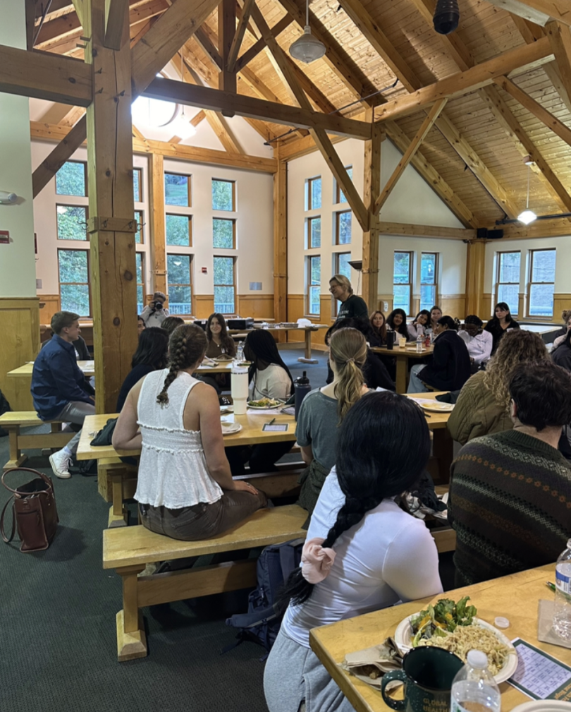A picture of fellows from all tables listening to one fellow speak.