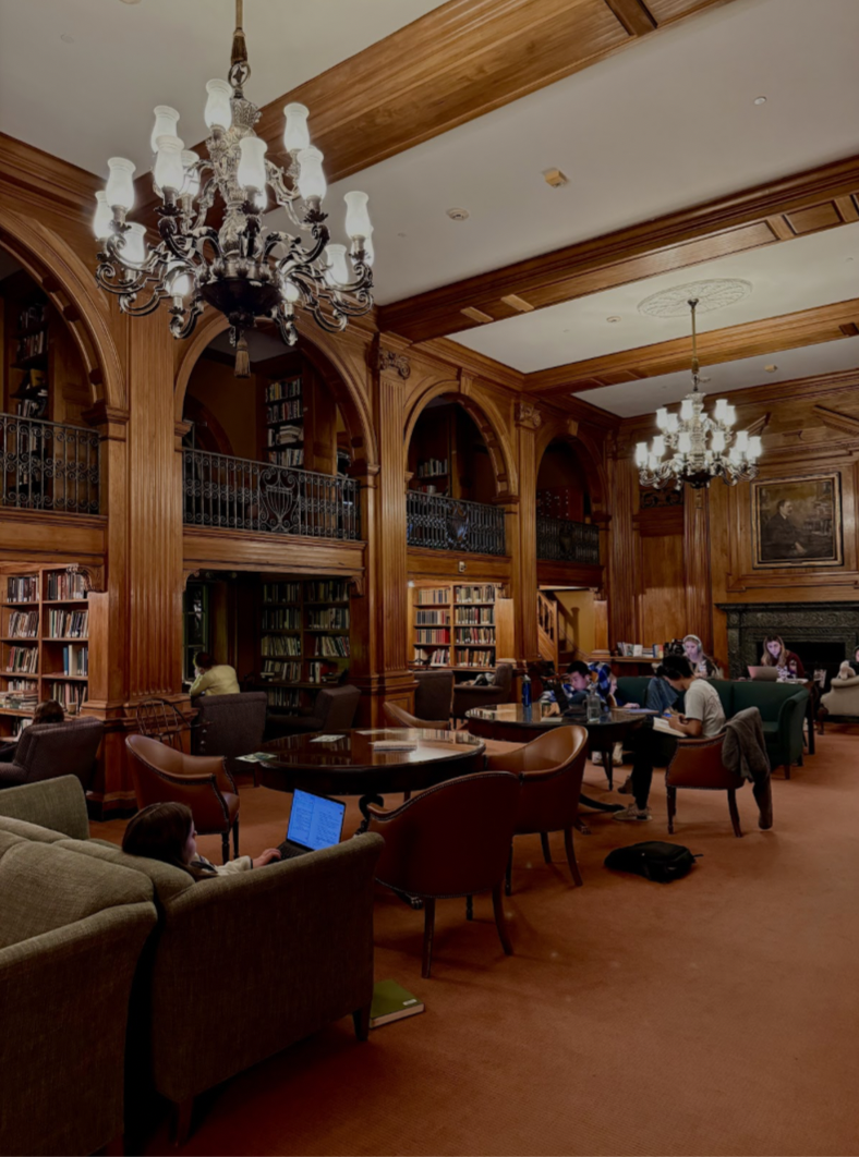 A library with chandeliers and comfortable chairs.