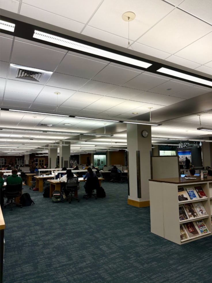 A large space with computers and students studying.
