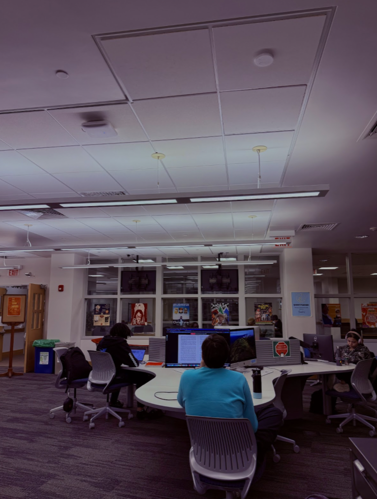 a space with computers and students studying.