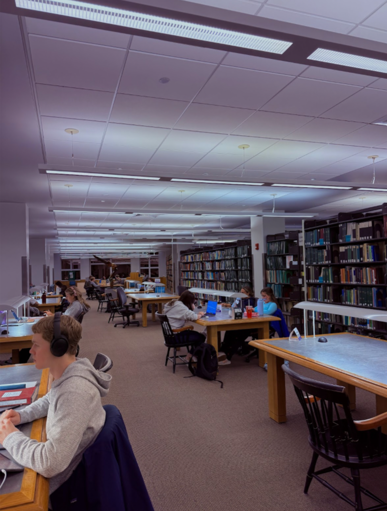a library with stacks of books and tables with students studying.