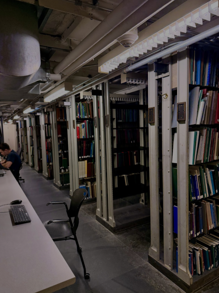stacks of books surrounded by tables.