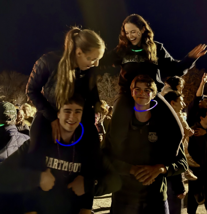 two smiling girls on the shoulders of two boys