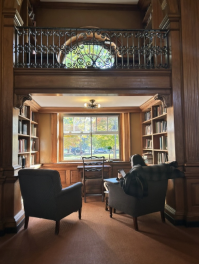 a room with two armchairs and a window looking outside