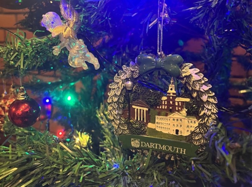An image of a Dartmouth themed Christmas ornament hanging on a Christmas tree