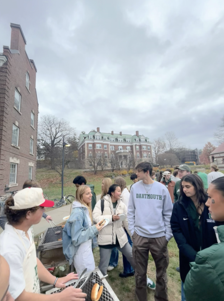 people standing in front of a grill
