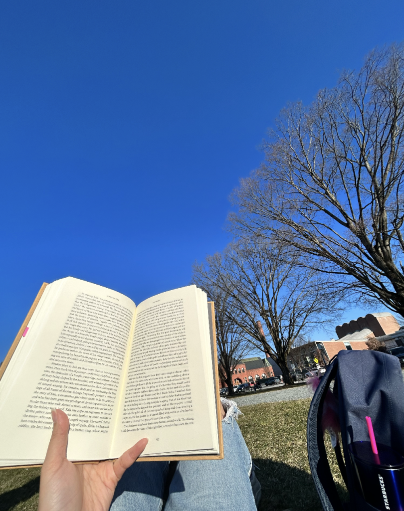 A picture of me reading a book on the Green